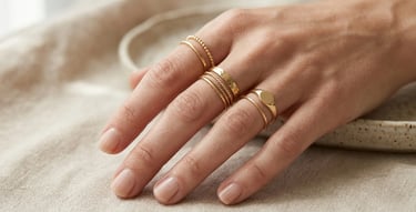 Minimalist gold midi rings stacked elegantly on stylish feminine fingers