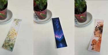 Three aesthetic bookmarks featuring floral, starry night, and portrait art next to a cactus.