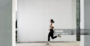 a woman running in a gym suit