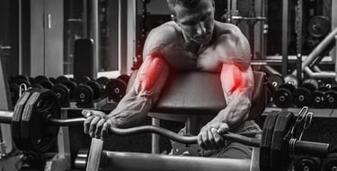 Bodybuilder performing preacher curls with an EZ curl bar to target biceps in a gym.