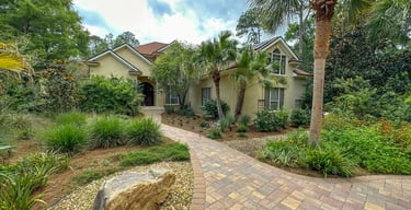 a house with a brick walkway and a stone path