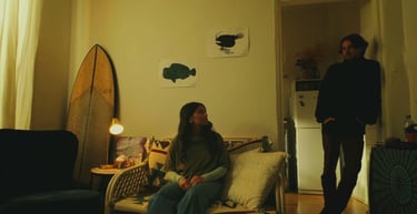 a man and woman sitting on a couch in a living room