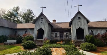 Mentone, AL - St. Joseph's church with an old log cabin in the middle
