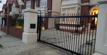 a gated in front of a house with a black gate