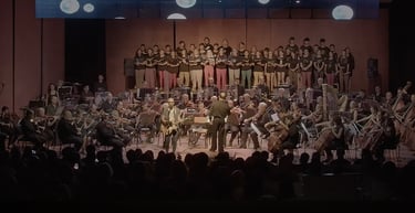 David De Mata with a conductor and orchestra in a concert hall