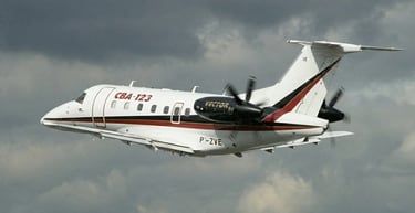 a plane flying through the air with a propeller embraer cba123