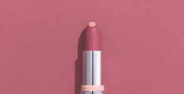 Avon Hydra Pink lipstick tube showing matte mauve color with a hydrating core against a pink background.