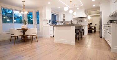 a kitchen with a table and chairs in the middle of the room