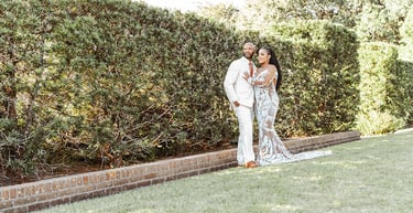 a bride and groom standing in front of a hedge in Louisiana