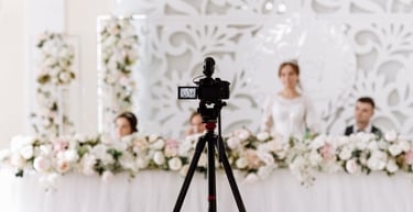 Glasgow wedding videographer filming bride and groom at a floral top table—cinematic reception cover