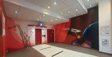 Modern ibis hotel lobby featuring red elevator doors and vibrant musical wall murals.
