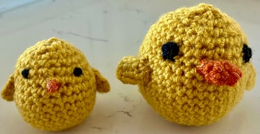 2 small yellow crocheted chicks