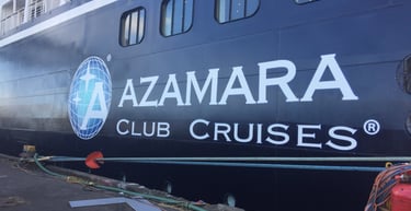 a large ship with a large sign that says azamara club cruise