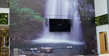 a large waterfall in a large room with a tv