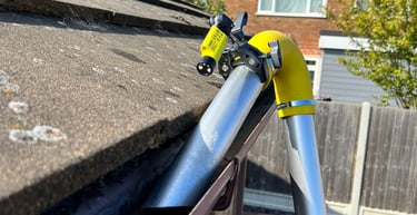 Vac gutter cleaning of a bungalow roof with an inspection camera attached