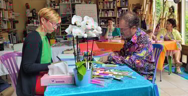 a woman is standing in front of a table with a blue table cloth