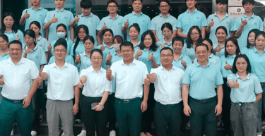 a group of people standing in front of a sign