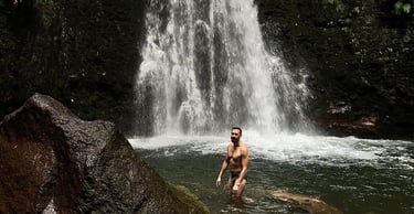 Gay man in waterfall at azores queer retreat