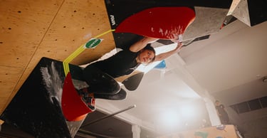woman climbing in a bouldering competition