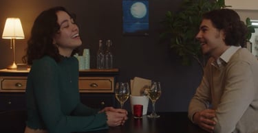 a man and woman sitting at a table