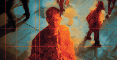 a man in a suit and tie is standing in front of a group of people