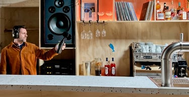 Un homme enregistre du son avec un sonomètre et un casque dans un bar