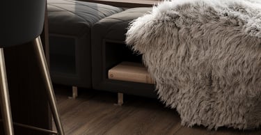 a couch with a fur rug and a chair