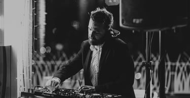 a dj spinning around a dj booth at a party
