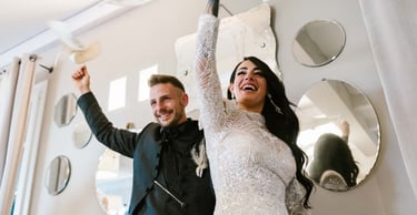 a man and woman standing in front of a mirror