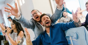 a man and woman sitting at a table with wine glasses