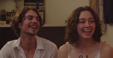 a man and woman sitting on a couch