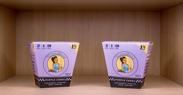 two cups of dispensary items on a shelf
