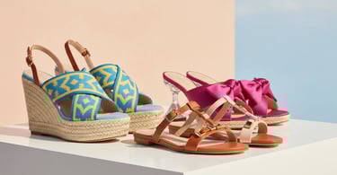 Elegant women's pastel summer heels on a sunny Mediterranean balcony.