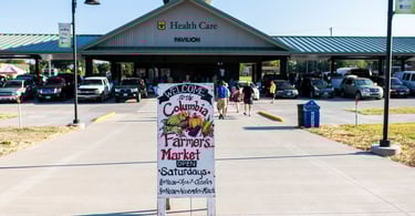 Photo taken of the Columbia Farmer's Market sign in front of the Farmer's Market pavilion