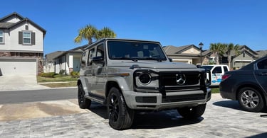 Gray Mercedes G-Wagon freshly detailed on a paver driveway in carrollwood neighborhood
