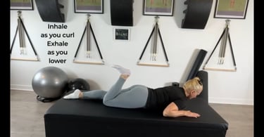 Woman executing a single leg curl from beginner Pilates Mat