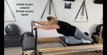 a woman working a thoracic twist on the reformer