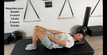 a man laying on a half roller to release tension in his spine