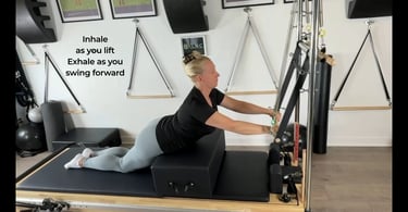 a woman kneeling with a box to assist learning spine extensions for rehabilitation