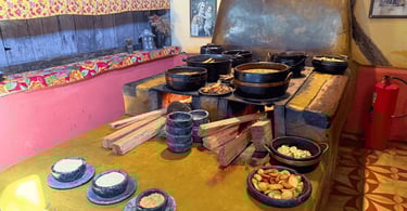 Fogão a lenha, com panelas de pedra e comidas mineiras em um restaurante em Itatiaia MG