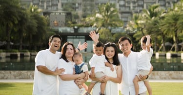 Family portrait with The Apurva Kempinski resort building in the background in Nusa Dua Bali