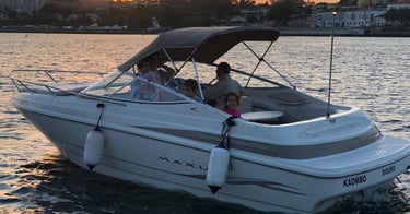 Family enjoying private boat tour at sunset on the Douro River in Porto, Portugal