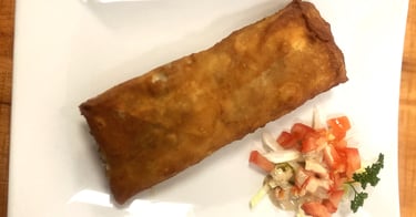 a plate of food on a table with a fork and knife
