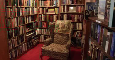 Chair in reading nook filled with used books at Chester Creek Books in Duluth, Minnesota