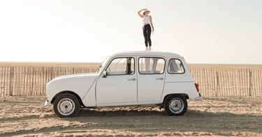 a woman standing on top of a car