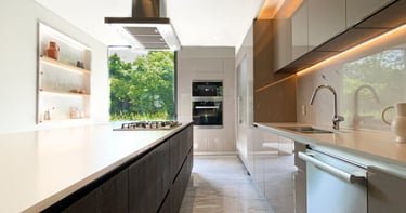 a kitchen with a long counter top and a large window