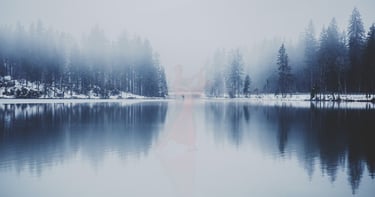 Ghostly figures dance on the surface of a lake