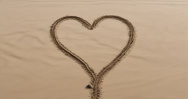 heart drawn on sand during daytime