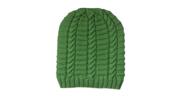 Green knitted ribbed cable beanie pattern on a white background.