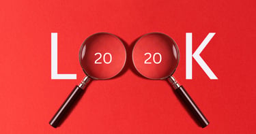 The word LOOK spelled with magnifying glasses over the zeros on a red background for 20/20 vision concept.